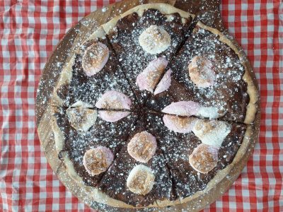 Delicious chocolate pizza topped with marshmallows and powdered sugar, perfect for dessert.