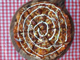 Delicious pizza with BBQ chicken and creamy sauce.